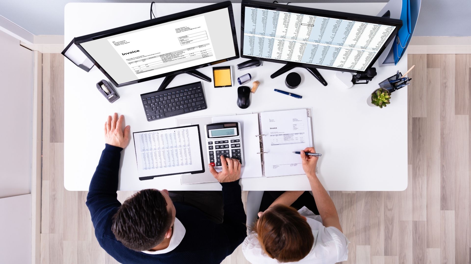 Auditors Working On Computer With Invoice